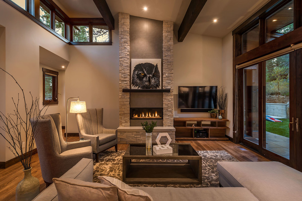 Mountain style dark wood floor and brown floor living room photo in Sacramento with beige walls and a ribbon fireplace