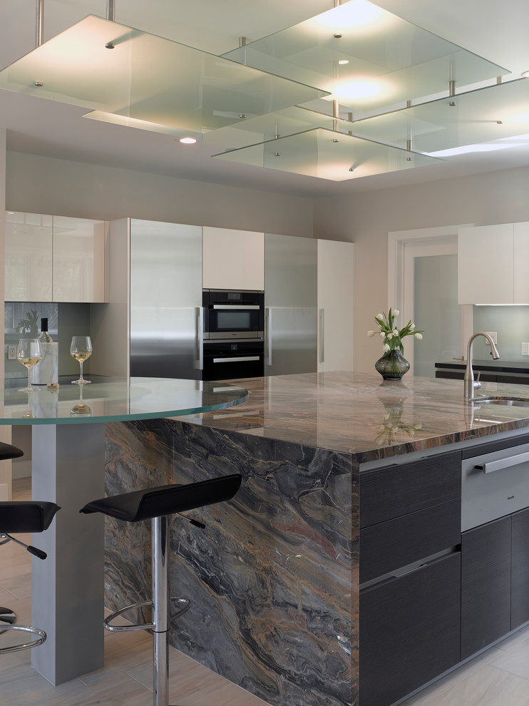 Design ideas for a large modern u-shaped open plan kitchen in San Francisco with an undermount sink, flat-panel cabinets, white cabinets, blue splashback, glass sheet splashback, stainless steel appliances, marble benchtops, light hardwood floors, multiple islands and brown floor.