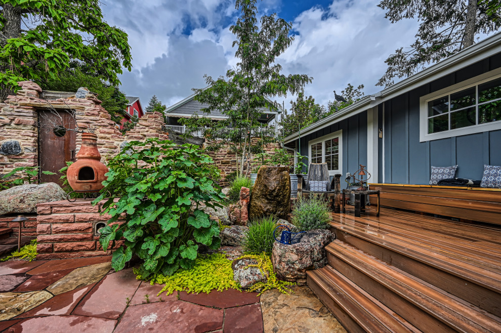 This is an example of a small rustic rock backyard stone landscaping in Denver.
