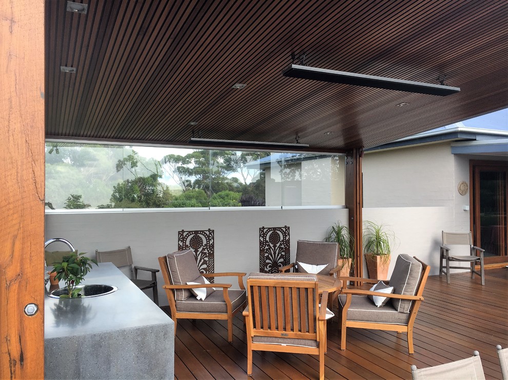 Photo of a mid-sized contemporary deck in Wollongong with a pergola.
