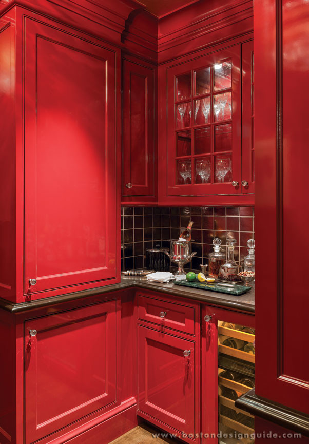 Photo of a traditional home bar in Boston with red cabinets.