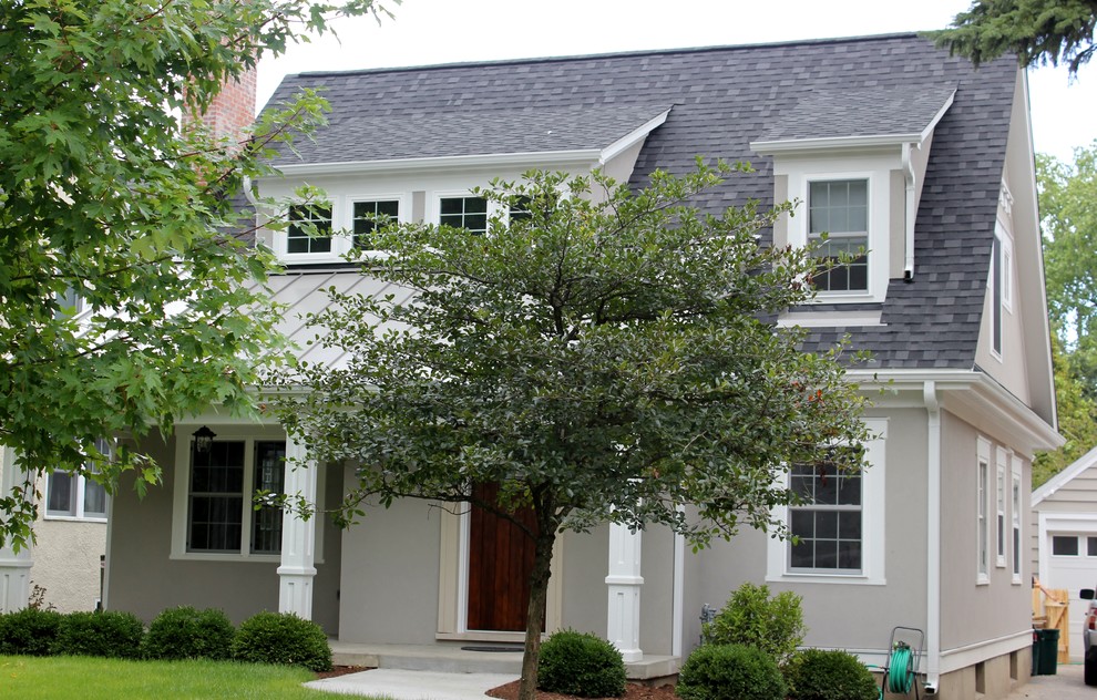 Mid-sized transitional beige two-story stucco gable roof idea in Chicago with a gray roof and a mixed material roof