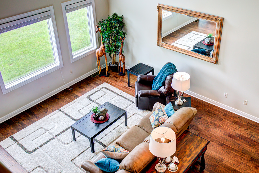 Mid-sized traditional open concept living room in Cincinnati with medium hardwood floors, beige floor, beige walls and no fireplace.