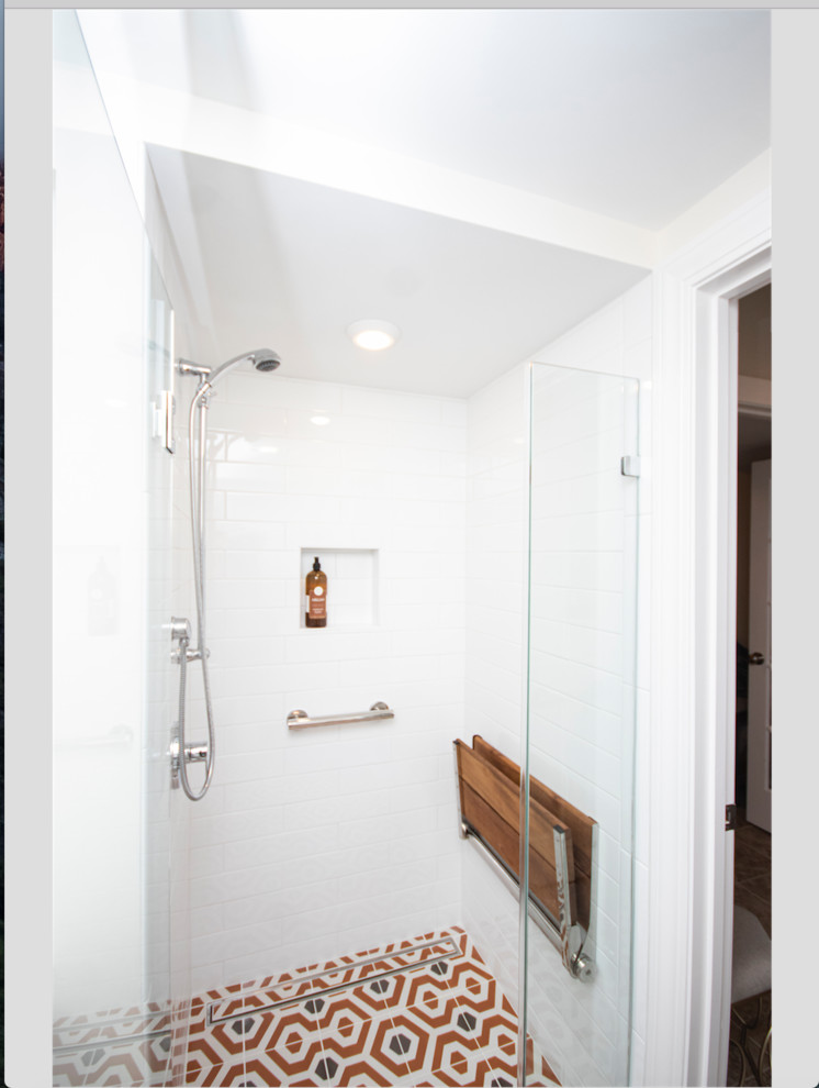 This is an example of a small eclectic master bathroom in Providence with recessed-panel cabinets, dark wood cabinets, a curbless shower, a two-piece toilet, white tile, subway tile, beige walls, mosaic tile floors, a drop-in sink, orange floor and a hinged shower door.