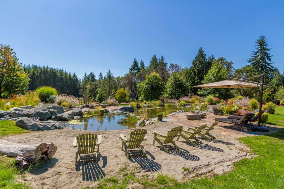 Pool fountain - huge rustic backyard custom-shaped full sun and natural pool fountain idea in Seattle