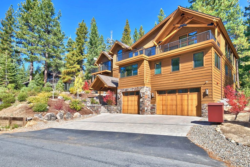 Large transitional brown three-story mixed siding gable roof idea with a shingle roof