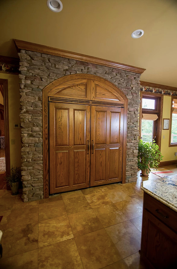 Eat-in kitchen - large rustic u-shaped porcelain tile and beige floor eat-in kitchen idea with an undermount sink, raised-panel cabinets, green cabinets, granite countertops, beige backsplash, porcelain backsplash, paneled appliances, an island and multicolored countertops