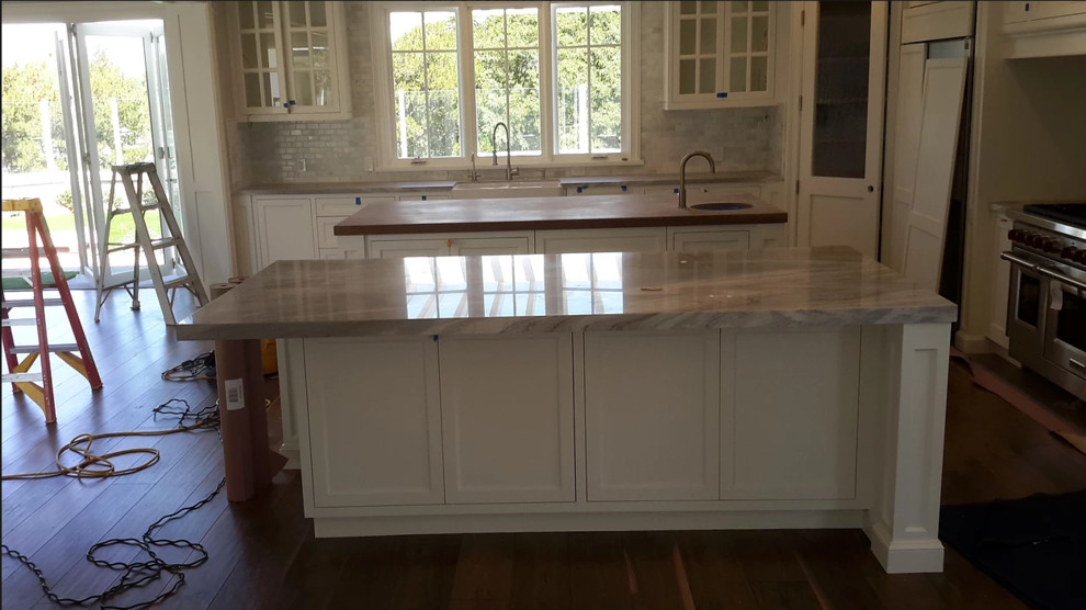 Huge open concept kitchen photo in Orange County with two islands