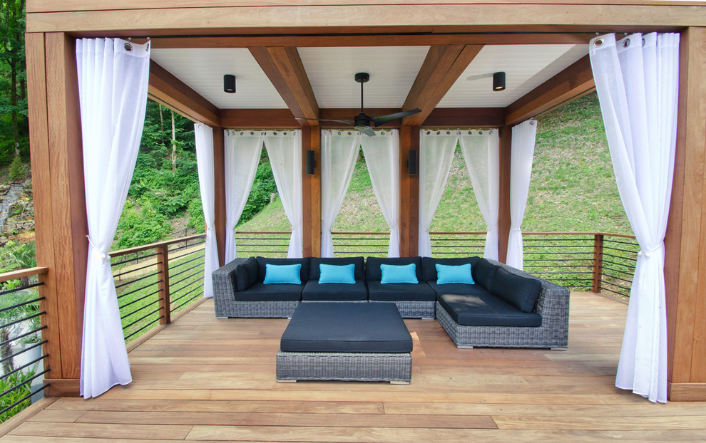 Mid-sized contemporary backyard deck in Nashville with a pergola.