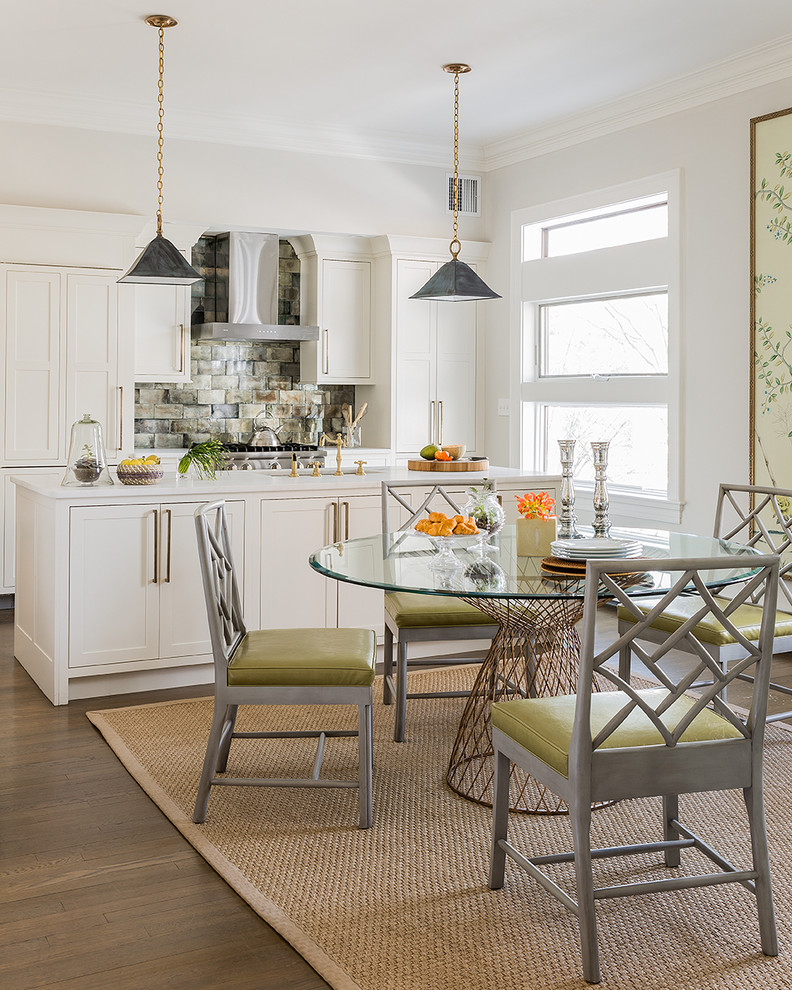 This is an example of a transitional kitchen/dining combo in Boston with white walls and medium hardwood floors.