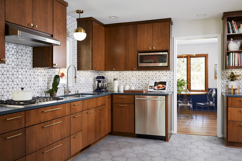 Mid-sized midcentury u-shaped separate kitchen in Minneapolis with an undermount sink, flat-panel cabinets, medium wood cabinets, quartz benchtops, white splashback, cement tile splashback, stainless steel appliances, cement tiles, no island, grey floor and black benchtop.