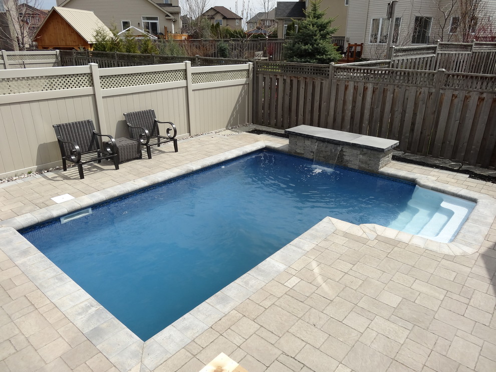 Traditional backyard custom-shaped natural pool in Ottawa with brick pavers.