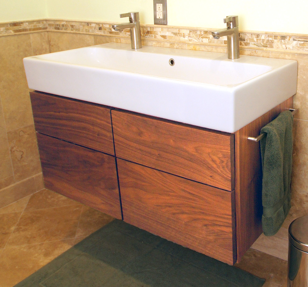 Photo of a small modern master bathroom in St Louis with flat-panel cabinets, medium wood cabinets, beige tile, ceramic floors and a trough sink.