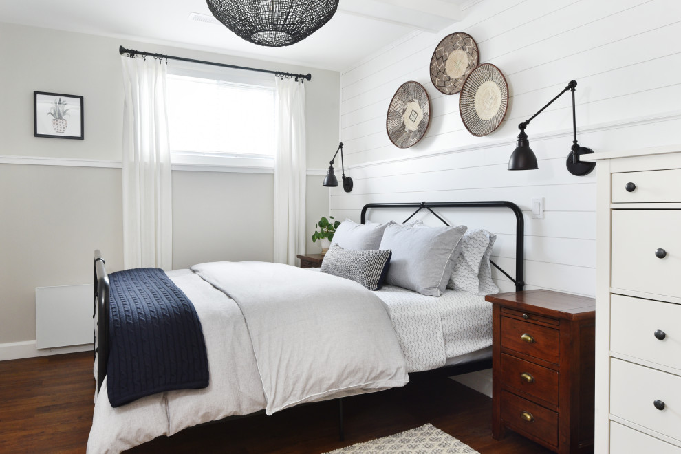 Design ideas for a country guest bedroom in Ottawa with white walls, medium hardwood floors, no fireplace, brown floor, exposed beam, planked wall panelling and decorative wall panelling.
