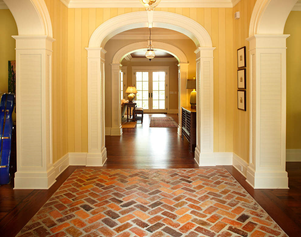 Design ideas for a country entryway in Other with beige walls, dark hardwood floors and brown floor.