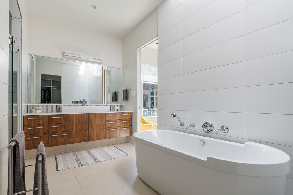 Mid-sized midcentury master bathroom in Houston with flat-panel cabinets, medium wood cabinets, a freestanding tub, an alcove shower, white tile, porcelain tile, white walls, porcelain floors, a vessel sink, engineered quartz benchtops, beige floor and a sliding shower screen.