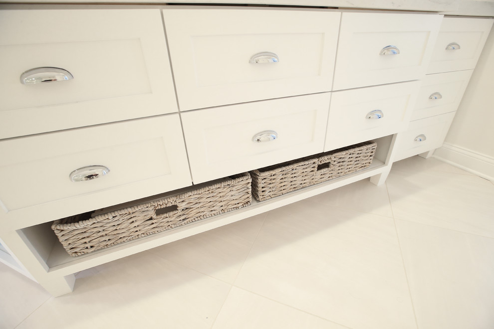 Inspiration for a mid-sized transitional master white tile and marble tile porcelain tile and white floor freestanding bathtub remodel with shaker cabinets, white cabinets, white walls, an undermount sink and marble countertops