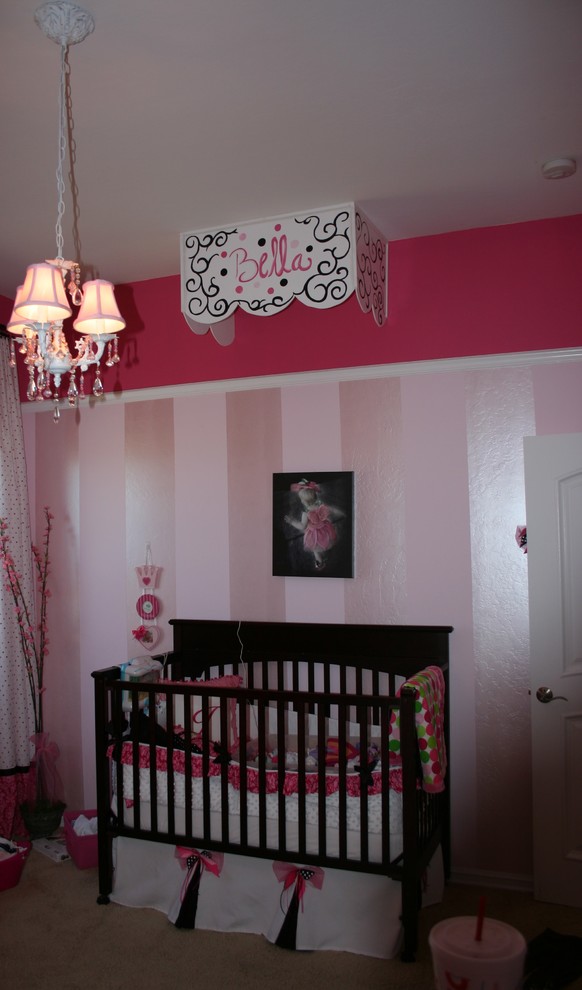 Design ideas for a mid-sized contemporary nursery for girls in Albuquerque with pink walls, carpet and beige floor.