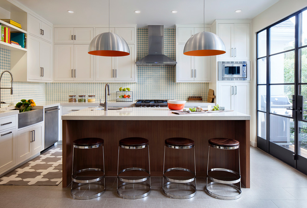 Design ideas for a transitional l-shaped eat-in kitchen in San Francisco with a farmhouse sink, shaker cabinets, white cabinets, quartz benchtops, blue splashback, cement tile splashback, stainless steel appliances, ceramic floors and with island.