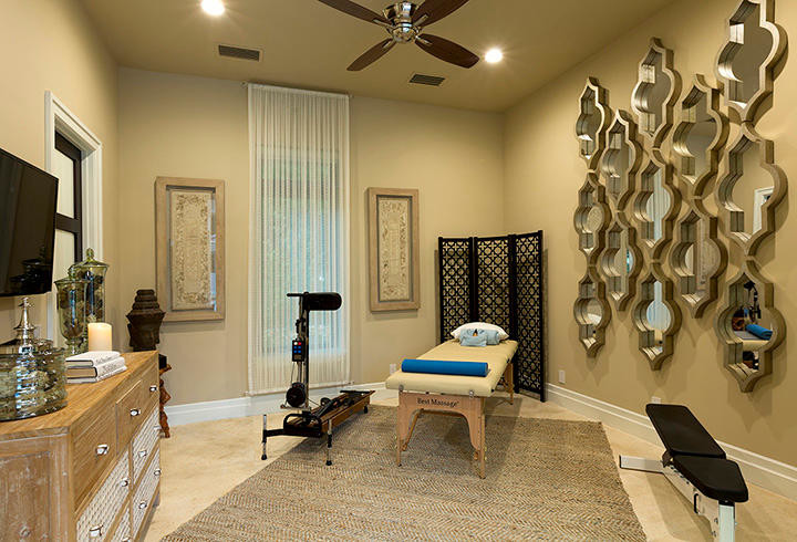 Design ideas for a large contemporary home yoga studio in Orlando with beige walls and travertine floors.