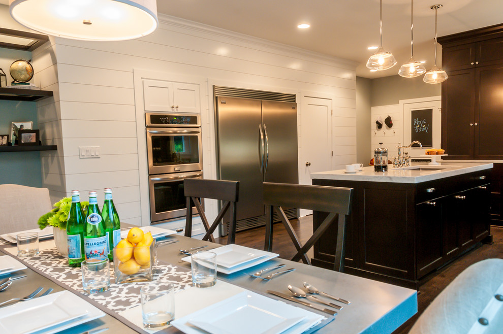 Mid-sized transitional l-shaped dark wood floor eat-in kitchen photo in Chicago with an undermount sink, recessed-panel cabinets, dark wood cabinets, quartzite countertops, multicolored backsplash, mirror backsplash, stainless steel appliances and an island
