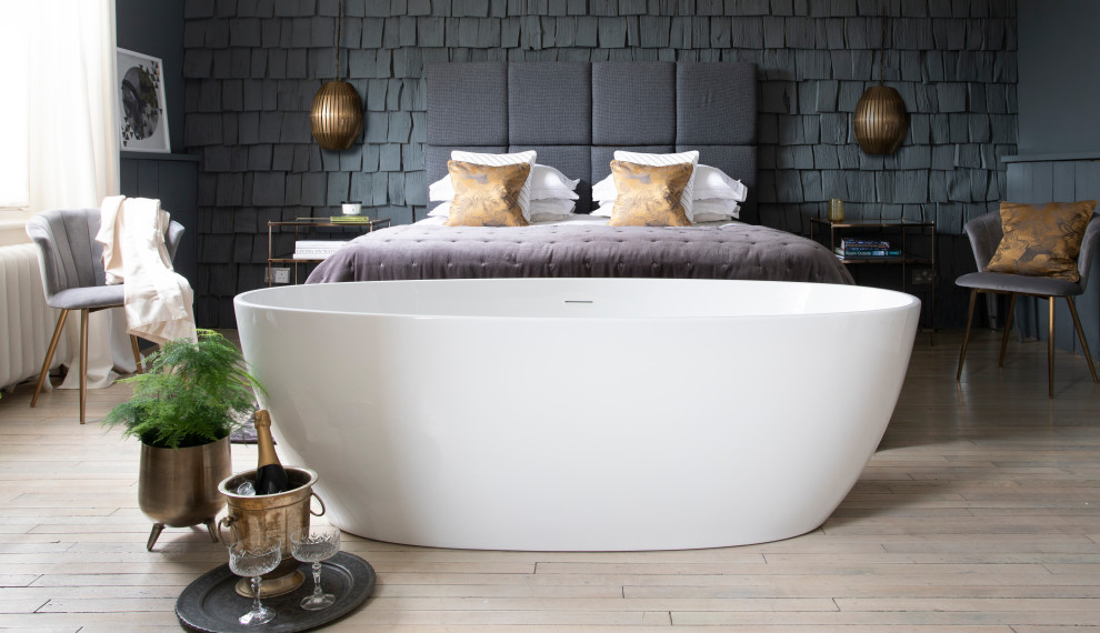 Large eclectic master bedroom with grey walls, light hardwood flooring, beige floors and wood walls.