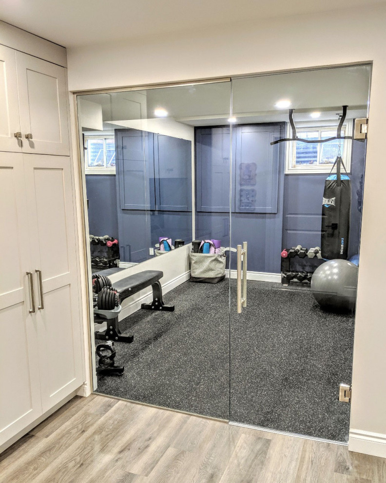 Photo of a mid-sized transitional multipurpose gym in Toronto with blue walls, vinyl floors and grey floor.
