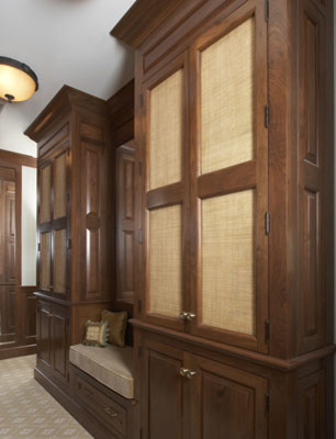 This is an example of a traditional storage and wardrobe in New York with dark wood cabinets.