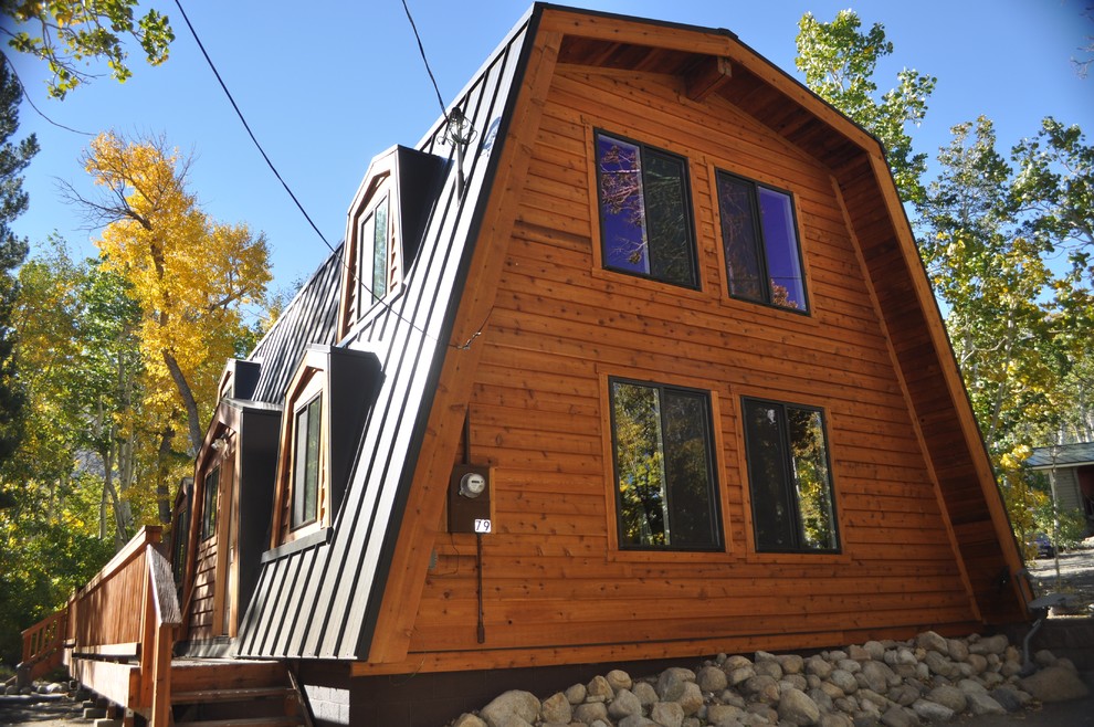 Large rustic brown two-story wood house exterior idea with a metal roof