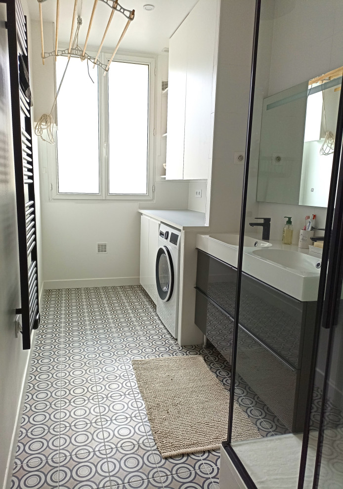 Photo of a medium sized contemporary grey and white shower room bathroom in Paris with beaded cabinets, grey cabinets, a corner shower, white tiles, ceramic tiles, white walls, cement flooring, a submerged sink, solid surface worktops, grey floors, a sliding door, white worktops, double sinks and a floating vanity unit.