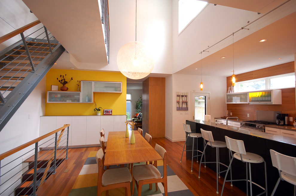 Design ideas for a modern open plan dining in Minneapolis with yellow walls and dark hardwood floors.