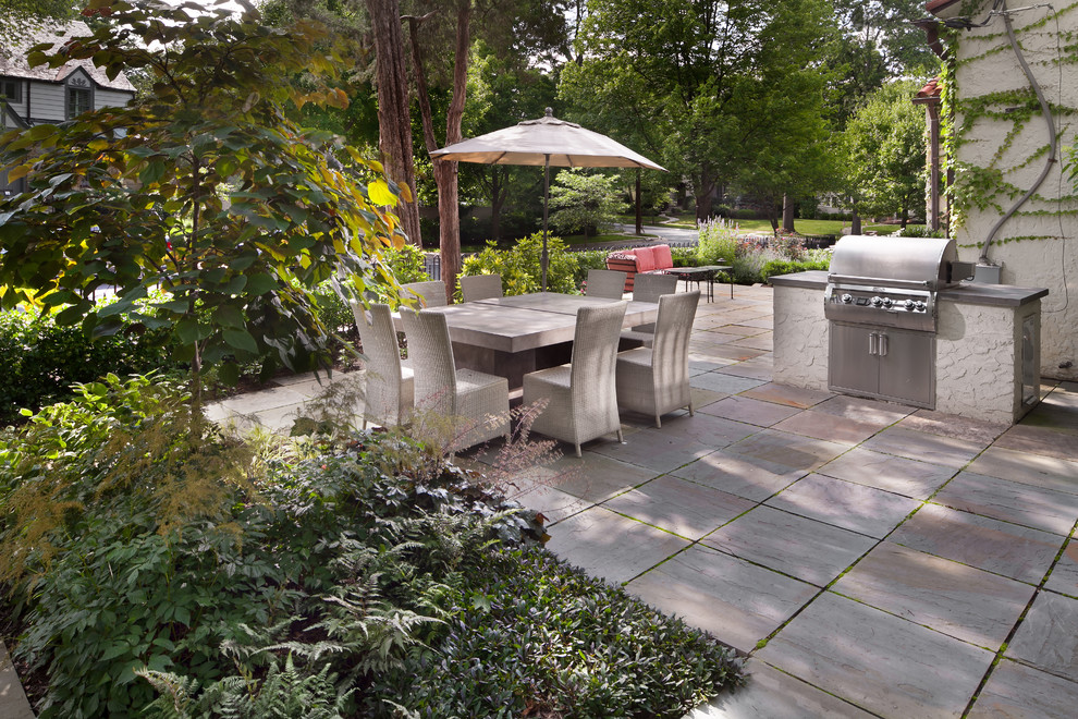 Mid-sized mediterranean side yard patio in DC Metro with natural stone pavers.