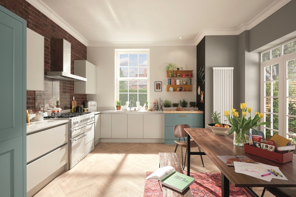 This is an example of a mid-sized scandinavian l-shaped eat-in kitchen in Dublin with an undermount sink, flat-panel cabinets, turquoise cabinets, quartzite benchtops, glass sheet splashback, white appliances, plywood floors and no island.