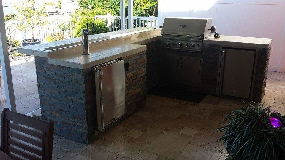 This is an example of a mid-sized country backyard patio in Jacksonville with an outdoor kitchen.