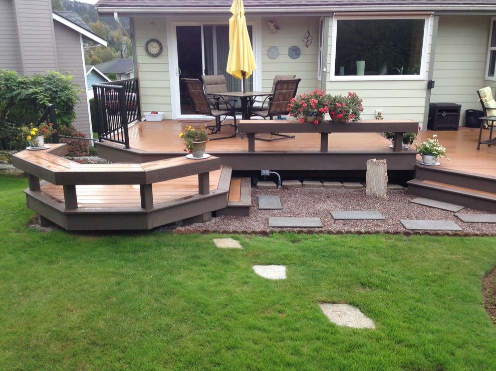 This is an example of a mid-sized contemporary backyard deck in Seattle with no cover.