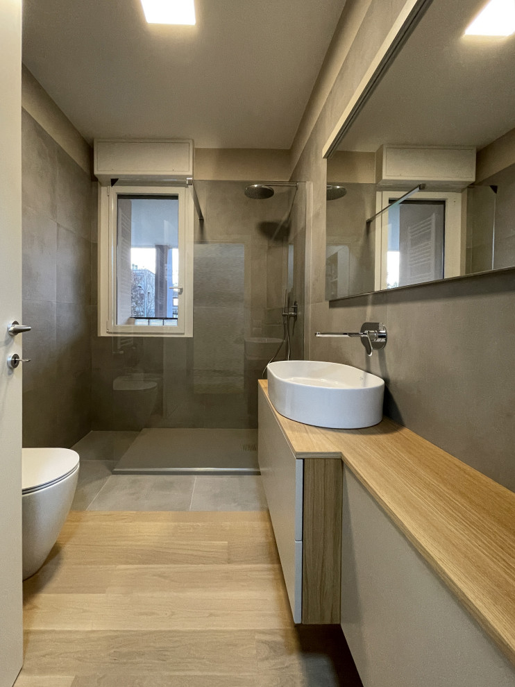 Inspiration for a mid-sized modern 3/4 bathroom in Milan with flat-panel cabinets, white cabinets, a curbless shower, a two-piece toilet, brown tile, stone tile, brown walls, medium hardwood floors, wood benchtops, brown floor, brown benchtops, a single vanity, a floating vanity and recessed.