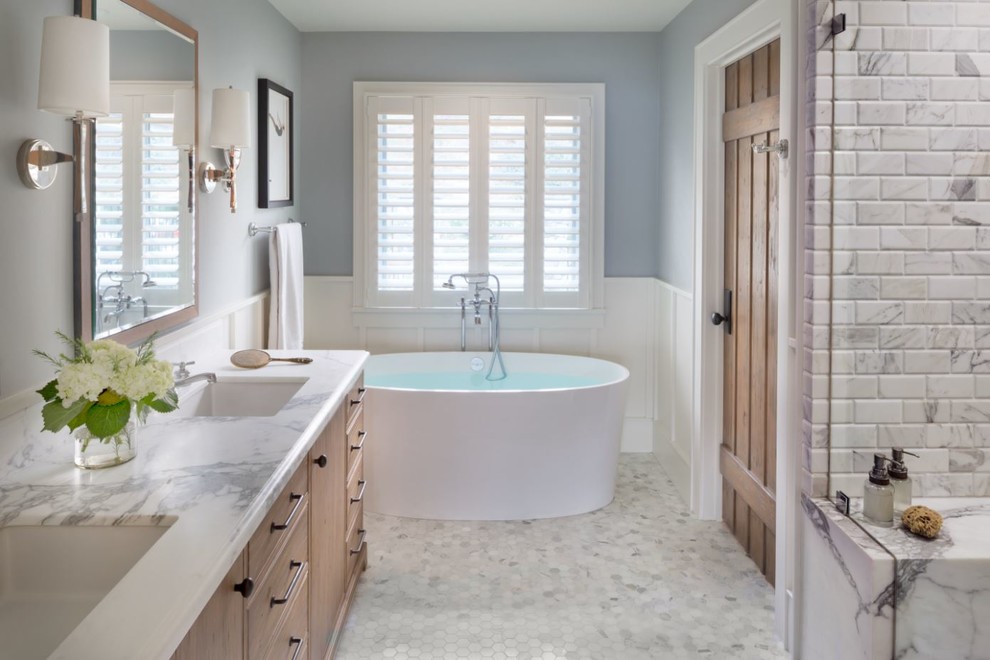 This is an example of a large beach style master bathroom in Los Angeles with furniture-like cabinets, light wood cabinets, a freestanding tub, an alcove shower, grey walls, marble floors, an undermount sink, marble benchtops, multi-coloured floor and multi-coloured benchtops.
