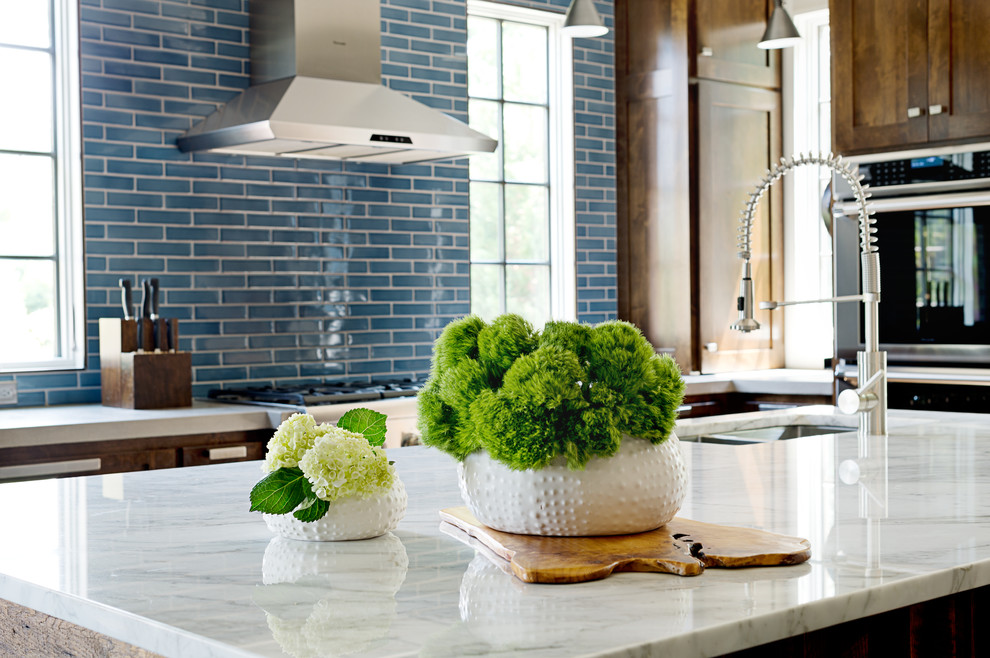 Large transitional u-shaped dark wood floor kitchen photo with an undermount sink, shaker cabinets, dark wood cabinets, concrete countertops, blue backsplash, subway tile backsplash, stainless steel appliances and an island