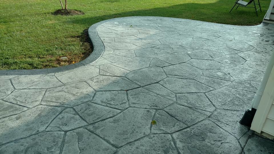 Design ideas for a large traditional backyard patio in Other with a fire feature, stamped concrete and no cover.
