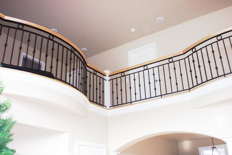 Example of a transitional wooden metal railing staircase design