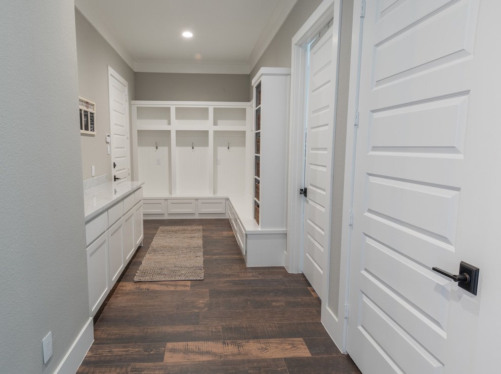 Design ideas for a mid-sized arts and crafts hallway in Houston with grey walls, dark hardwood floors and brown floor.
