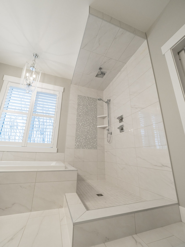 Design ideas for a large traditional master bathroom in Edmonton with recessed-panel cabinets, white cabinets, a drop-in tub, an open shower, a two-piece toilet, white tile, marble, white walls, marble floors, a drop-in sink, marble benchtops, white floor and a sliding shower screen.