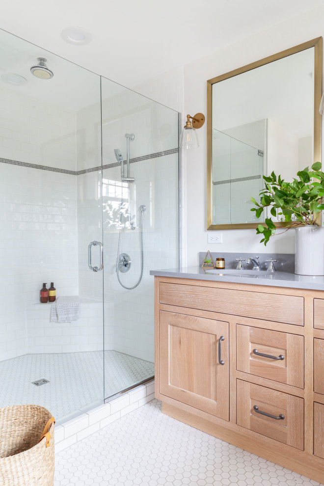 Alcove shower - mid-sized transitional master white tile ceramic tile, white floor and double-sink alcove shower idea in Chicago with shaker cabinets, light wood cabinets, a two-piece toilet, gray walls, a drop-in sink, quartz countertops, a hinged shower door, gray countertops and a freestanding vanity