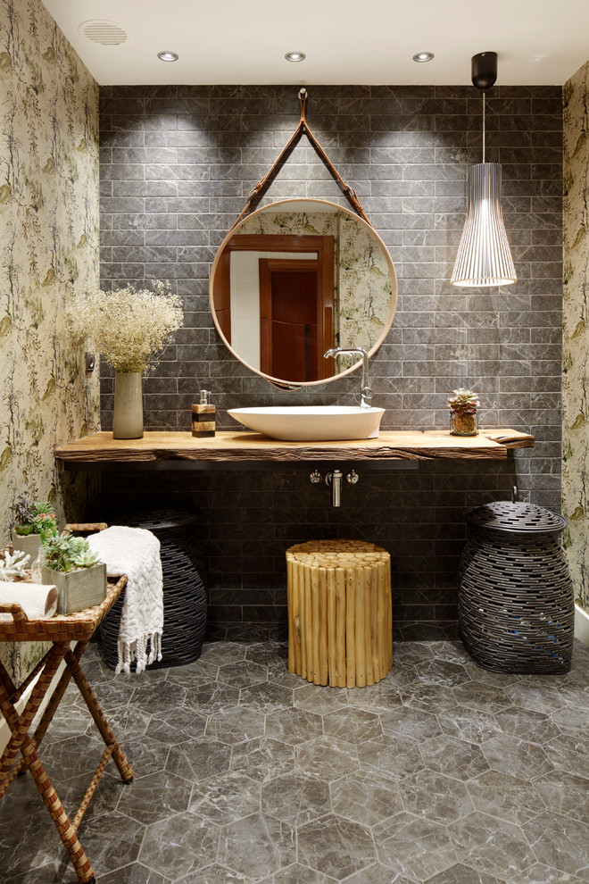 Inspiration for a zen gray tile and subway tile gray floor bathroom remodel in Other with a vessel sink, wood countertops and brown countertops