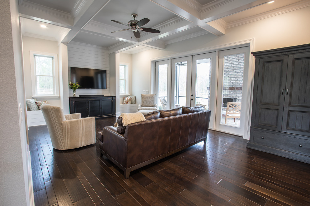 Mid-sized country open concept living room in Orlando with grey walls, dark hardwood floors and a wall-mounted tv.
