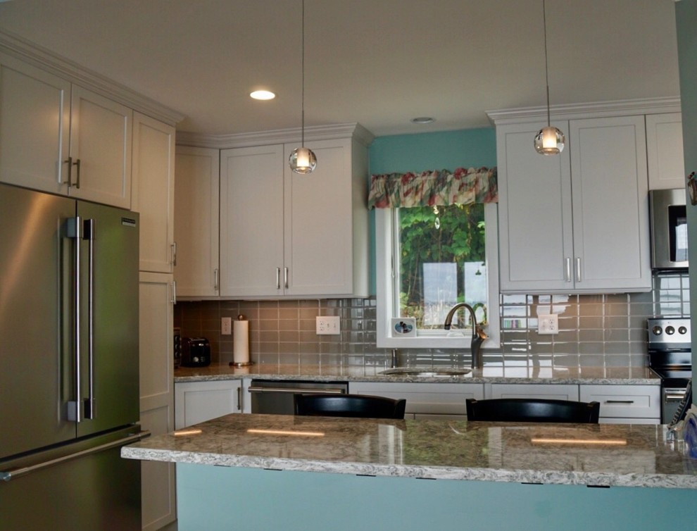 Eat-in kitchen - small transitional galley porcelain tile and gray floor eat-in kitchen idea in Boston with a single-bowl sink, shaker cabinets, white cabinets, quartz countertops, gray backsplash, glass tile backsplash, stainless steel appliances and a peninsula