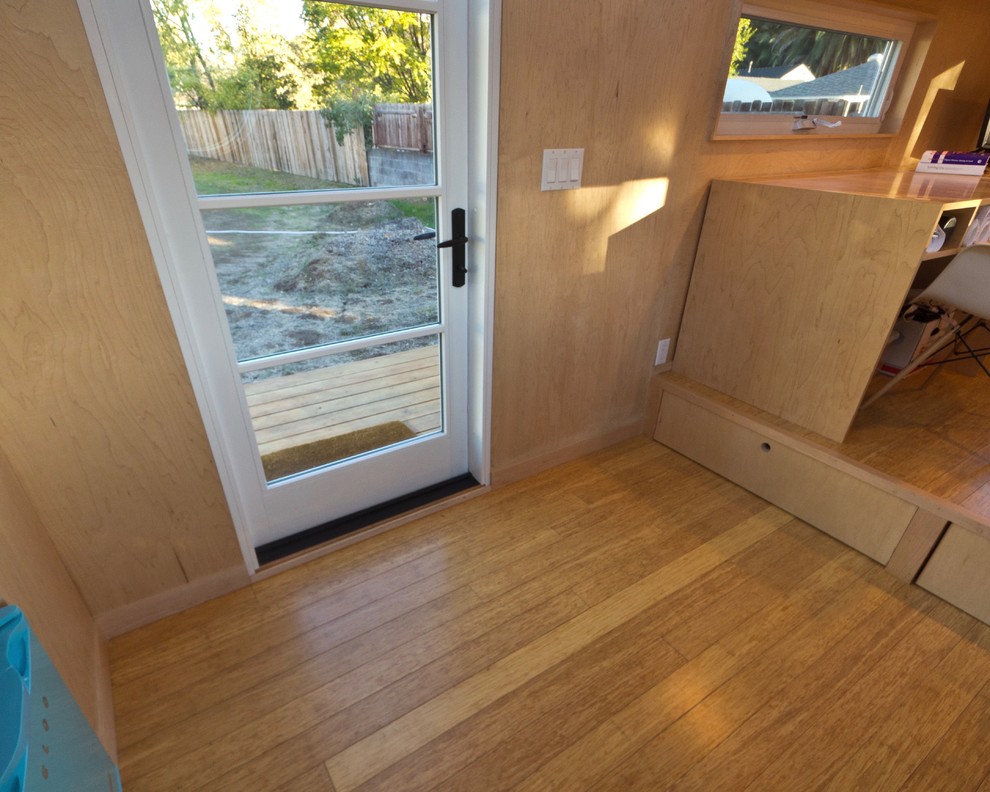 Photo of a small modern entryway in Santa Barbara with white walls and bamboo floors.
