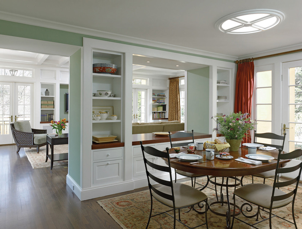 Photo of a traditional dining room in Philadelphia with green walls, dark hardwood floors and brown floor.