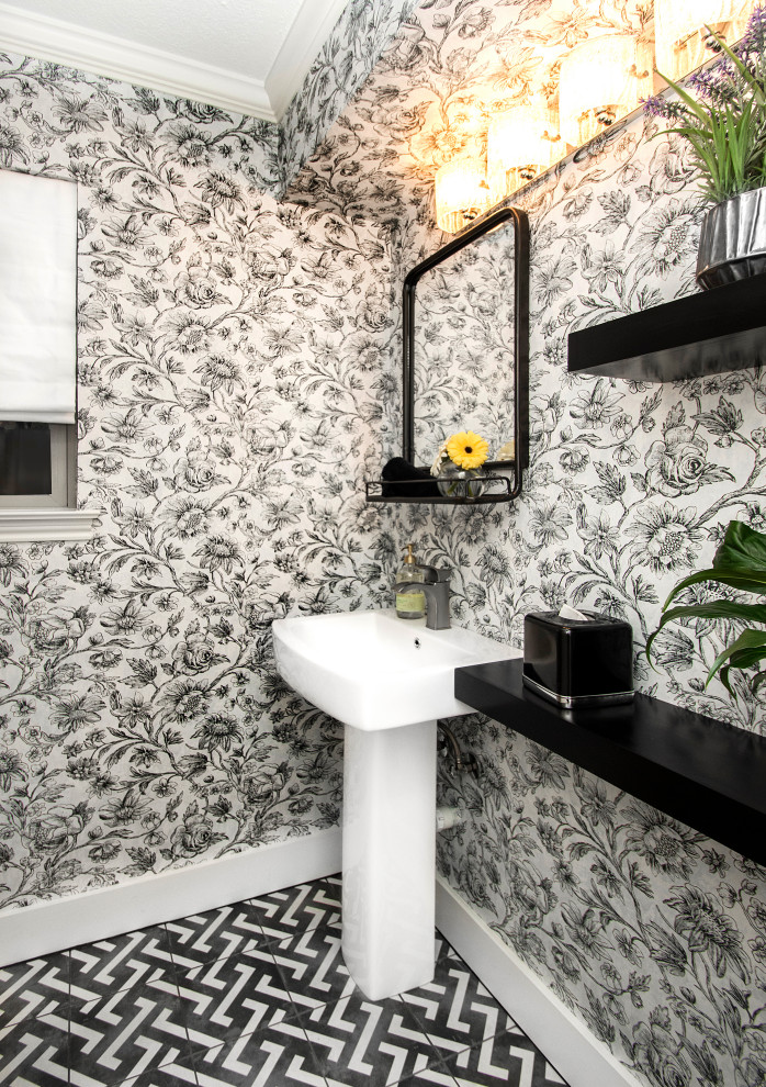Small transitional 3/4 bathroom in Dallas with white cabinets, a corner shower, a two-piece toilet, multi-coloured walls, dark hardwood floors, a pedestal sink, multi-coloured floor, a hinged shower door, a single vanity, a freestanding vanity and wallpaper.