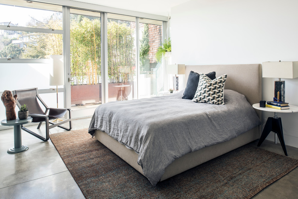 Inspiration for a contemporary bedroom in San Francisco with white walls and concrete floors.
